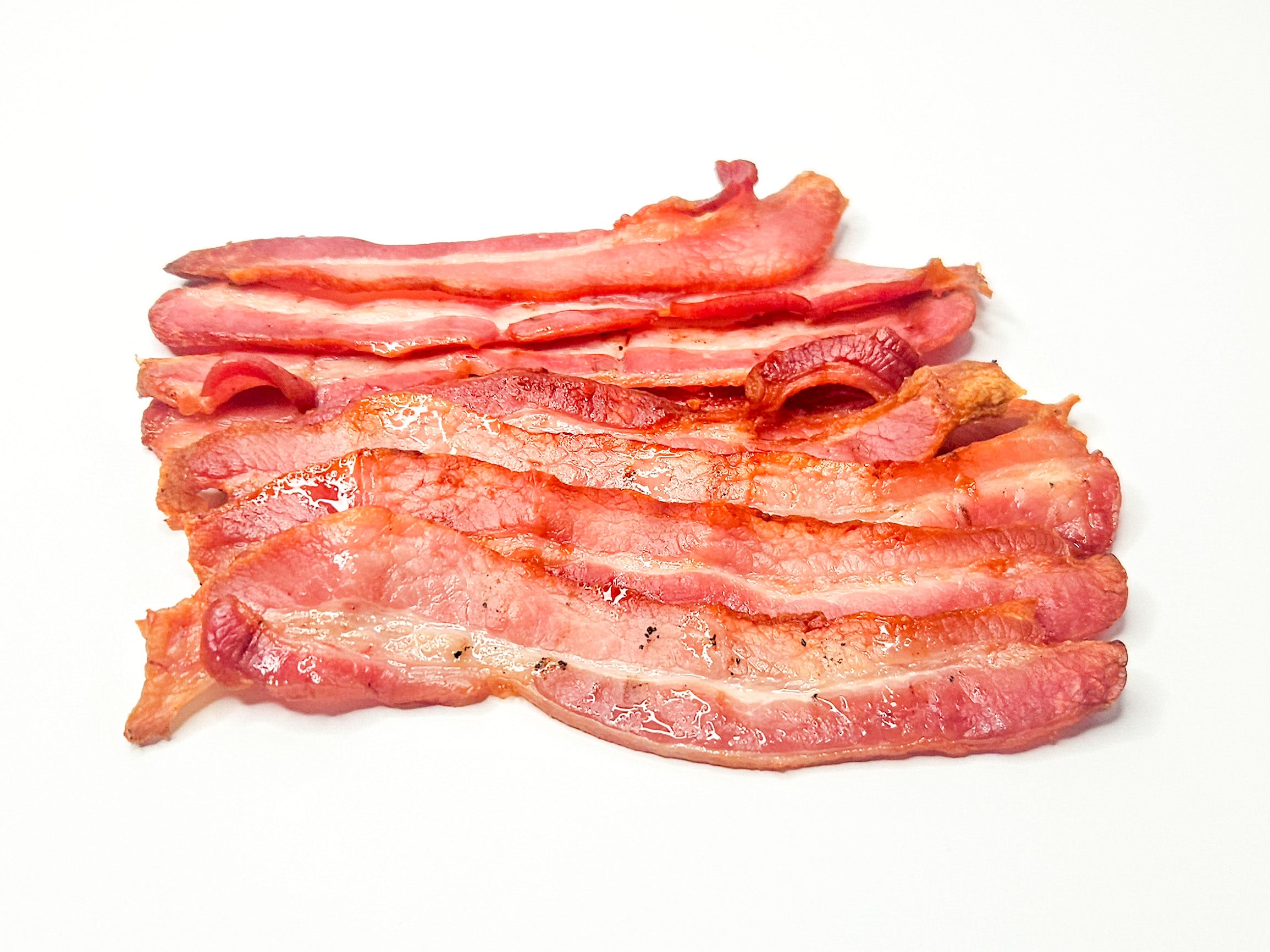 Cooked streaky bacon slices